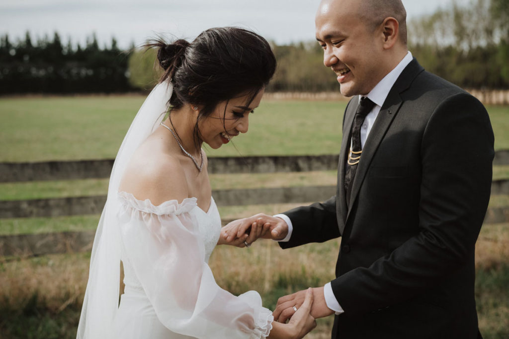 Bride  & Groom holding hands and laughing with each other. Photo taken by Tracey Allsopp Photography 